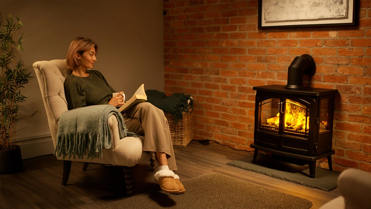 Family relaxing beside a glowing Dimplex Optimyst electric fire