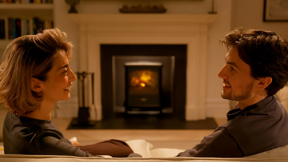 Family relaxing beside a glowing Dimplex Optimyst electric fire