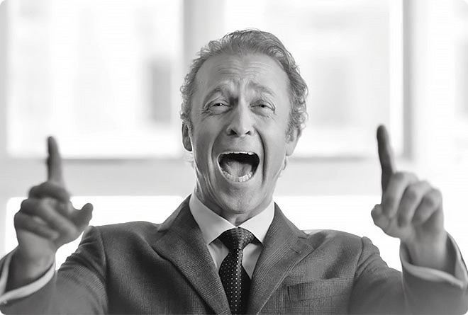 A bank manager laughing hysterically with his hands in the air